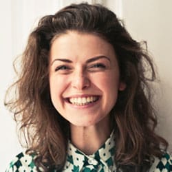 Smiling client testimonial portrait, curly-haired woman